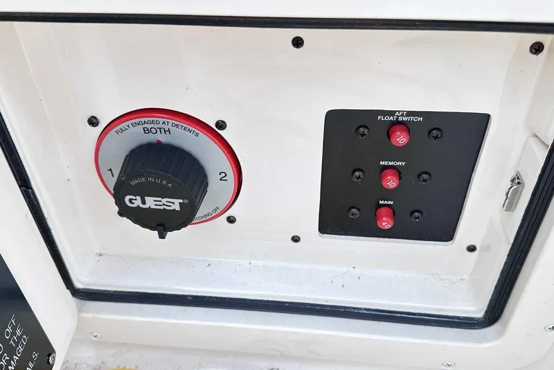 Slide: The Image of Control panel of a 2007 Grady-White Tournament 225 boat with switches and dials. - 33