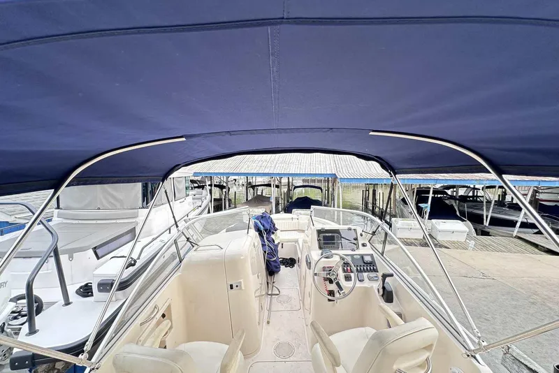 Slide: The Image of 2007 Grady-White Tournament 225 boat interior with blue canopy at marina. - 5