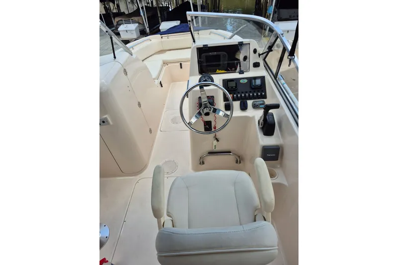 Slide: The Image of 2007 Grady-White Tournament 225 boat cockpit with steering wheel and control panel. - 13