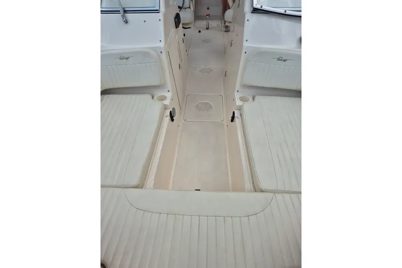 Slide: The Image of 2007 Grady-White Tournament 225 boat interior with cushioned seating and storage compartments. - 26