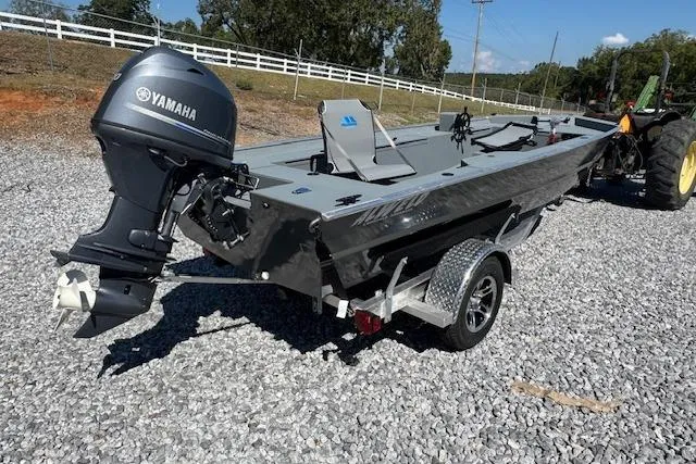 Slide: The Image of 2025 Alweld 1856 PF boat with Yamaha motor on gravel, near a tractor. - 3
