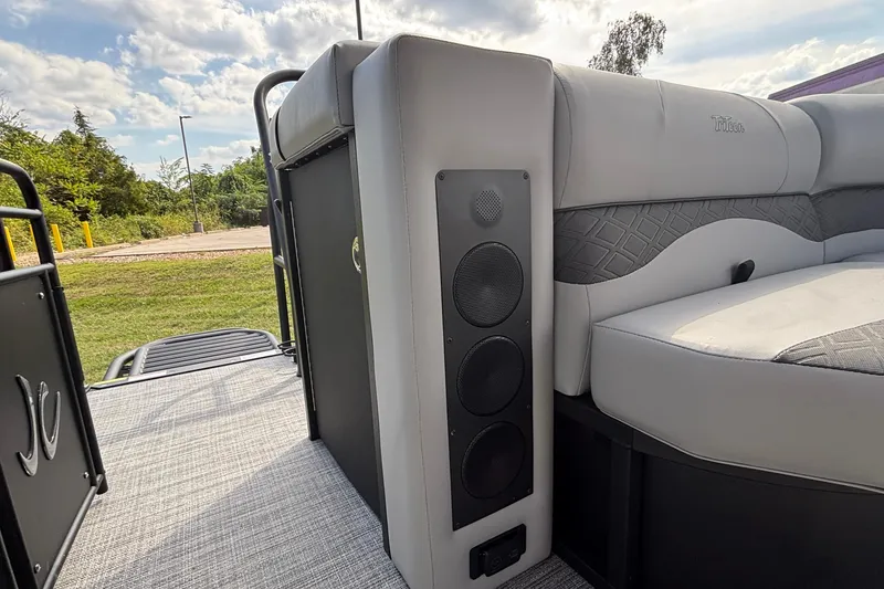 Slide: The Image of 2026 JC NEPTOON 27TT SPORT boat interior with gray seating and speaker system. - 18