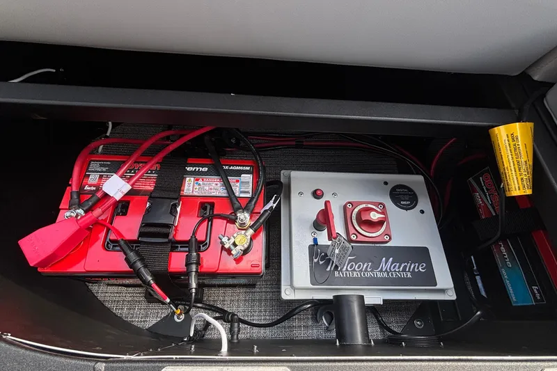 Slide: The Image of Battery control center of 2026 JC NEPTOON 27TT SPORT with red cables and switches. - 20