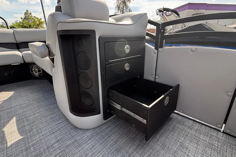 Slide: The Image of Interior of 2026 JC NEPTOON 27TT SPORT boat with open storage drawer and speaker system. - 38