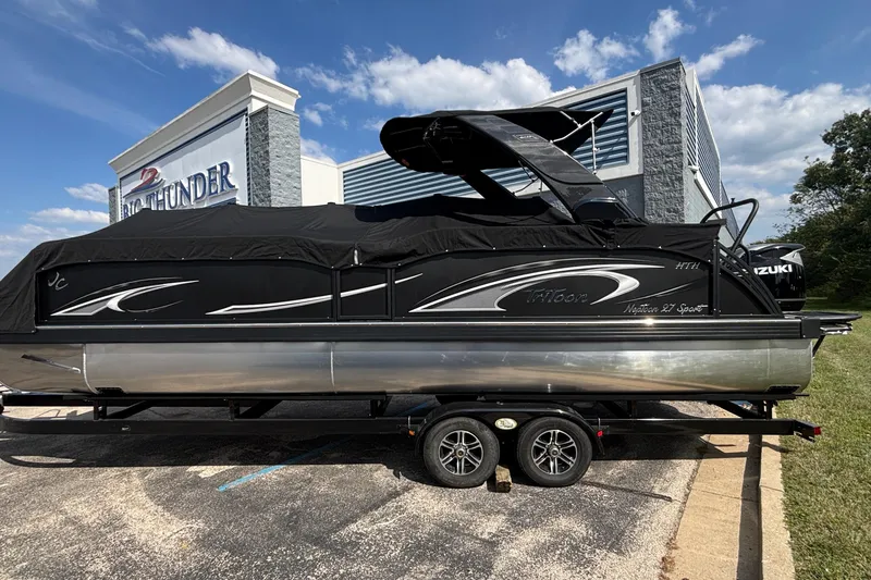 Slide: The Image of 2026 JC NEPTOON 27TT SPORT pontoon boat with black cover, parked at dealership. - 4