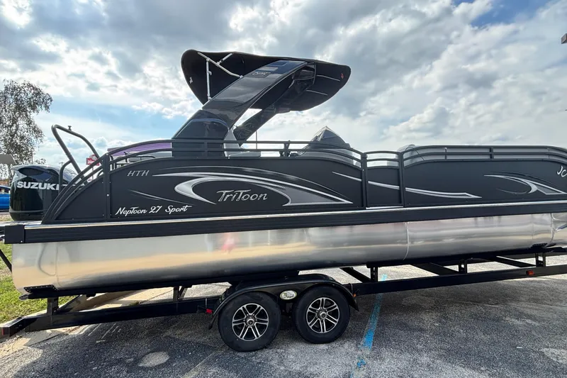 Slide: The Image of 2026 JC Neptoon 27TT Sport pontoon boat on trailer under cloudy sky. - 46