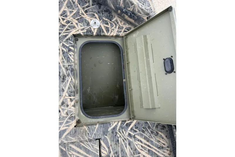 Slide: The Image of Open storage compartment on 2016 Lowe Roughneck 1756SC boat with camouflage pattern. - 10