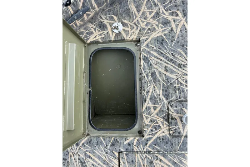 Slide: The Image of 2016 Lowe Roughneck 1756SC boat storage compartment with camouflage pattern. - 6