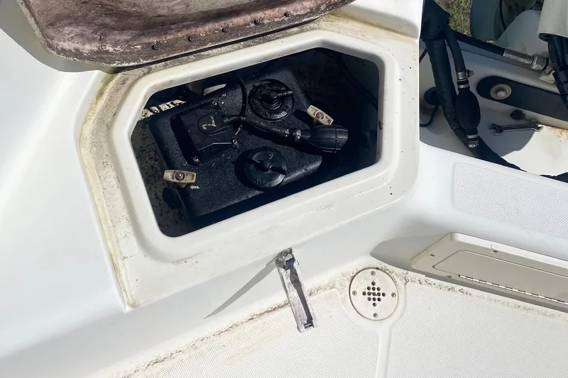 Slide: The Image of Open storage compartment on a 2003 Hydra-Sports 180 CC boat, showing internal components. - 12