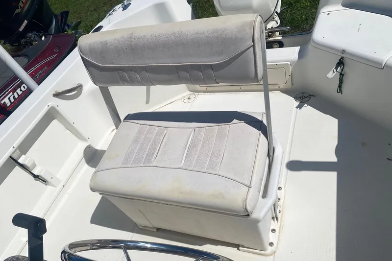 Slide: The Image of 2003 Hydra-Sports 180 CC boat interior with white cushioned seating and steering wheel. - 9