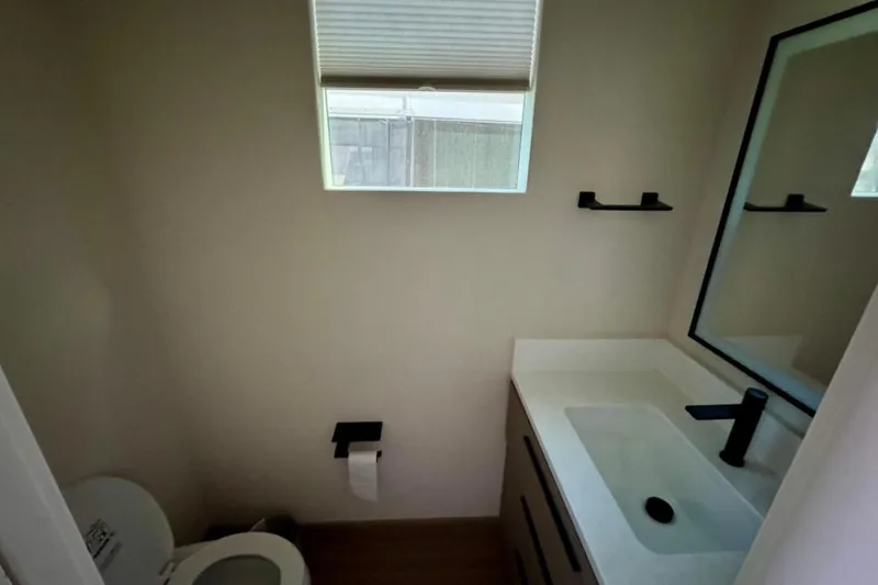 Slide: The Image of Compact bathroom in Adonia Aspire Trip #7, 2024 model, featuring modern sink and toilet. - 11