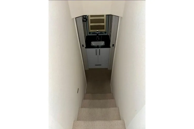 Slide: The Image of Narrow staircase leading to a compact bathroom in Adonia Aspire Trip #7, 2024 model. - 12
