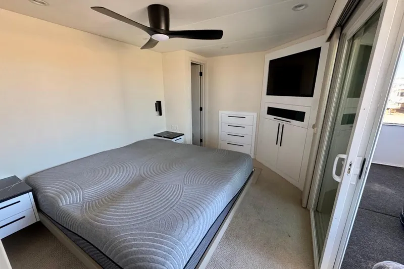 Slide: The Image of Modern bedroom in 2024 Adonia Aspire Trip #7 with sleek design and ceiling fan. - 13