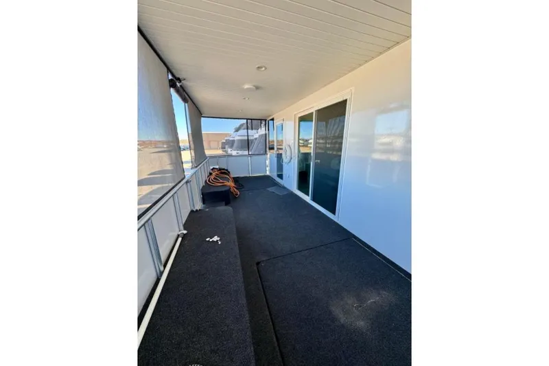 Slide: The Image of Covered deck area of 2024 Adonia Aspire Trip #7 houseboat with sliding glass doors. - 16