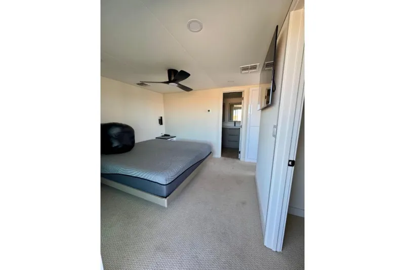 Slide: The Image of Bedroom interior of 2024 Adonia Aspire Trip #7, featuring modern design and ceiling fan. - 18