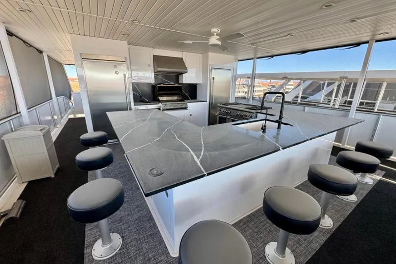 Slide: The Image of Modern kitchen on Adonia Aspire Trip #7 houseboat, featuring sleek countertops and bar stools, 2024 model. - 22