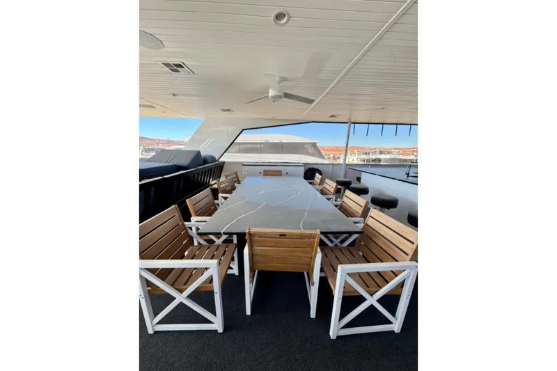 Slide: The Image of Outdoor dining area on 2024 Adonia Aspire Trip #7 yacht with wooden chairs and table. - 23