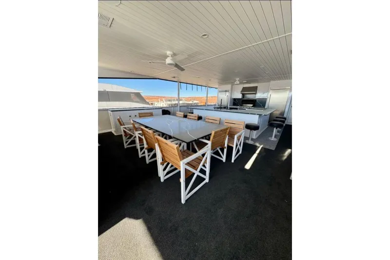 Slide: The Image of Outdoor dining area on Adonia Aspire Trip #7, 2024 model, featuring modern seating and kitchen amenities. - 24