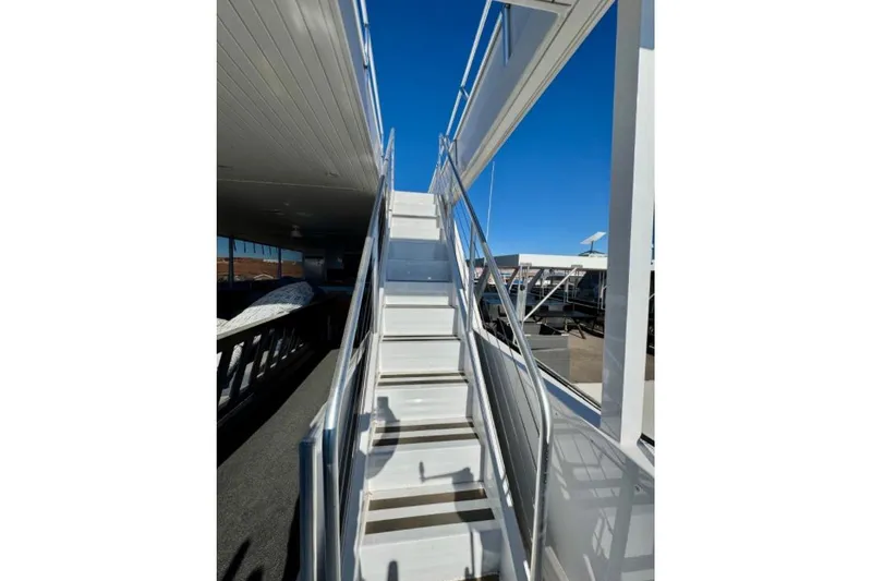 Slide: The Image of Staircase on Adonia Aspire Trip #7 houseboat, 2024 model, under clear blue sky. - 27