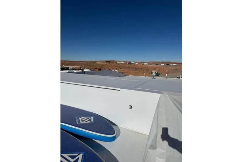 Slide: The Image of Rooftop view of Adonia Aspire Trip #7, 2024 model, with paddleboards and desert landscape. - 29