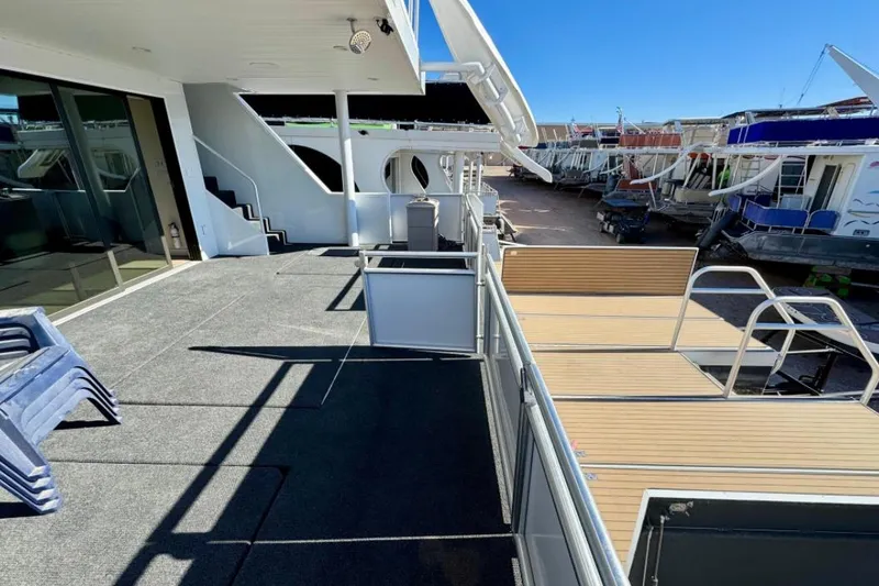 Slide: The Image of Deck view of 2024 Adonia Aspire Trip #7 houseboat with outdoor seating and stairs. - 30