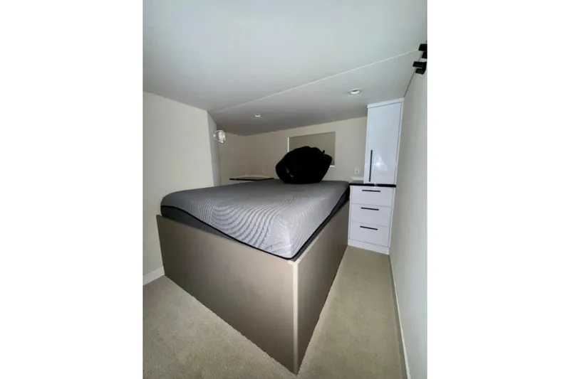 Slide: The Image of Compact bedroom in 2024 Adonia Aspire Trip #7 with elevated bed and storage. - 8