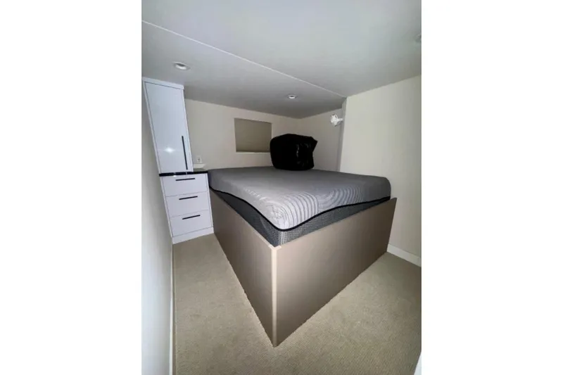 Slide: The Image of Compact bedroom in 2024 Adonia Aspire Trip #7 with elevated bed and storage. - 9