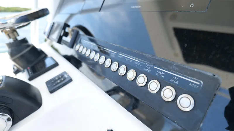 Slide: The Image of Control panel of a 2017 Edgewater 262CC boat with labeled buttons. - 12