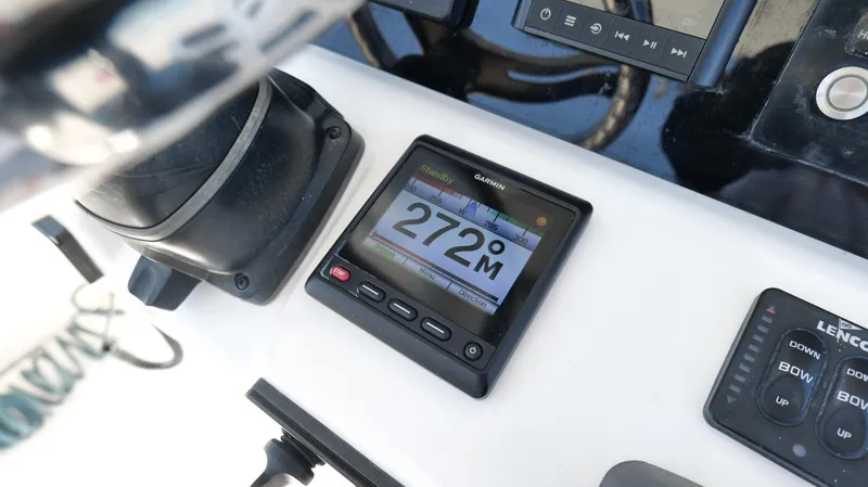 Slide: The Image of Control panel of 2017 Edgewater 262CC boat with Garmin display showing 272 meters. - 13