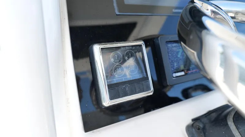 Slide: The Image of Close-up of 2017 Edgewater 262CC boat dashboard with digital display and controls. - 15