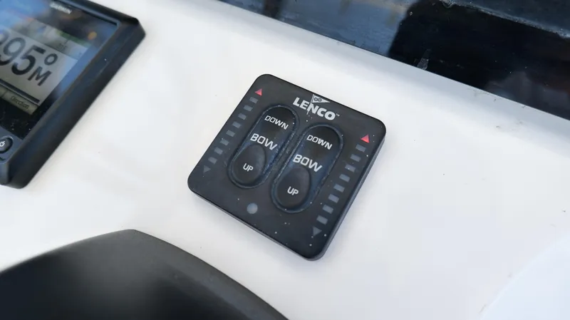 Slide: The Image of Lenco trim tab control panel on 2017 Edgewater 262CC boat dashboard. - 16