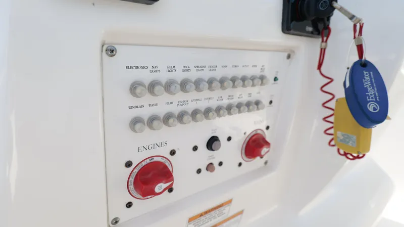 Slide: The Image of Control panel of a 2017 Edgewater 262CC boat with switches and engine controls. - 17