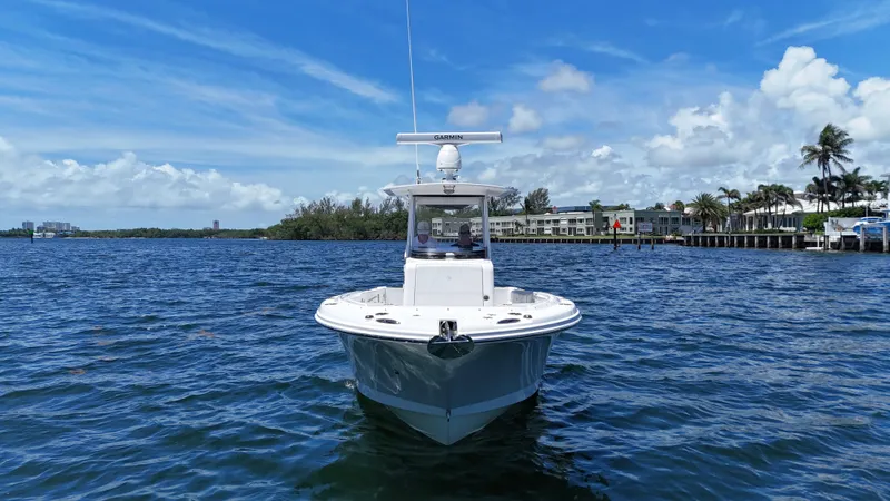 Slide: The Image of 2017 Edgewater 262CC boat on calm water with a clear blue sky backdrop. - 2