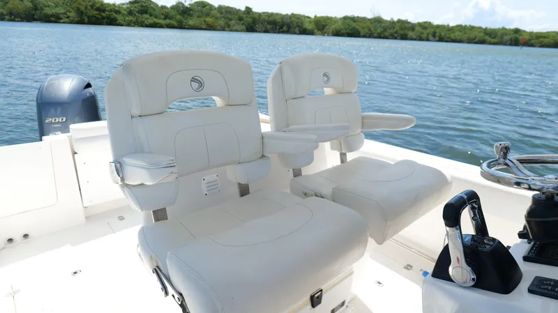 Slide: The Image of Luxurious seating on a 2017 Edgewater 262CC boat, overlooking serene waters. - 20