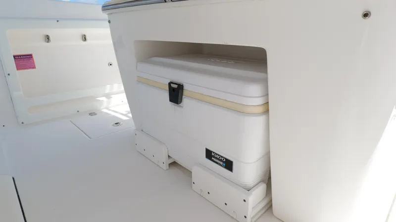 Slide: The Image of 2017 Edgewater 262CC boat with built-in cooler storage compartment. - 22