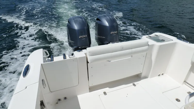 Slide: The Image of 2017 Edgewater 262CC boat with twin 200 horsepower engines on open water. - 23