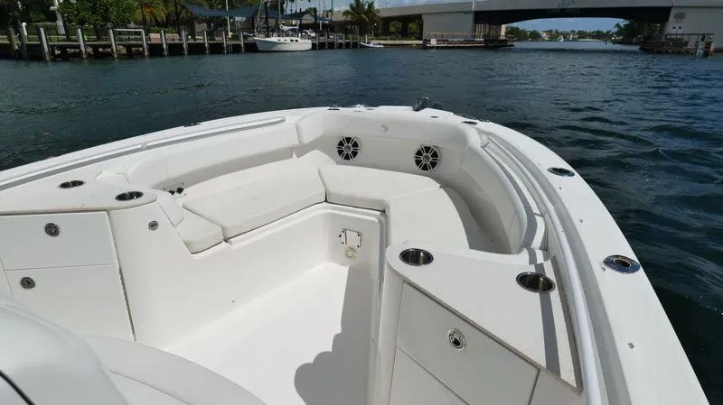 Slide: The Image of 2017 Edgewater 262CC boat interior with seating, cup holders, and water view. - 40