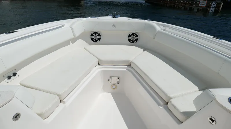 Slide: The Image of 2017 Edgewater 262CC boat interior with white cushioned seating and speakers. - 41