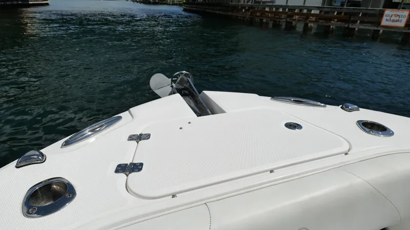 Slide: The Image of Bow of a 2017 Edgewater 262CC boat on water near a dock. - 43