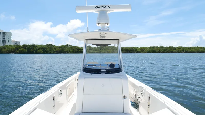 Slide: The Image of 2017 Edgewater 262CC boat on calm water with Garmin equipment, clear sky background. - 44