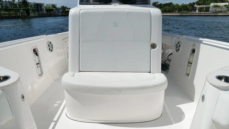 Slide: The Image of 2017 Edgewater 262CC boat interior with white seating and water view. - 45