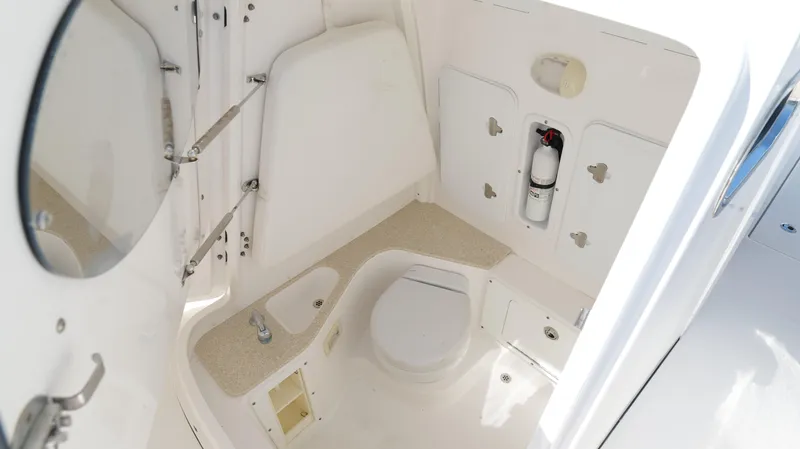 Slide: The Image of 2017 Edgewater 262CC boat interior with compact bathroom and storage features. - 47