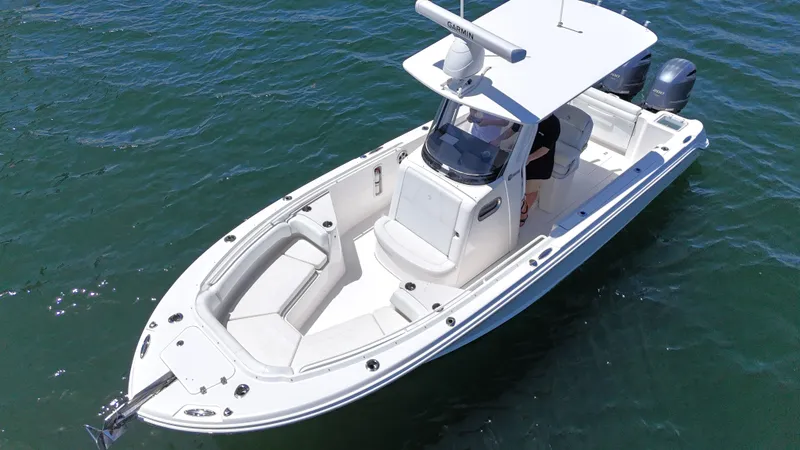 Slide: The Image of 2017 Edgewater 262CC boat on water, featuring sleek design and spacious seating. - 8