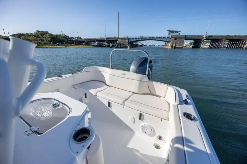 Slide: The Image of 2023 Sea Hunt Ultra 234 boat interior with bridge view in background. - 18