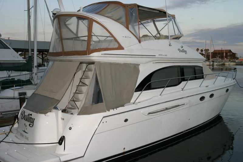 The Image of 2005 Meridian 411 Sedan yacht docked at marina, featuring elegant design and spacious upper deck. - 0