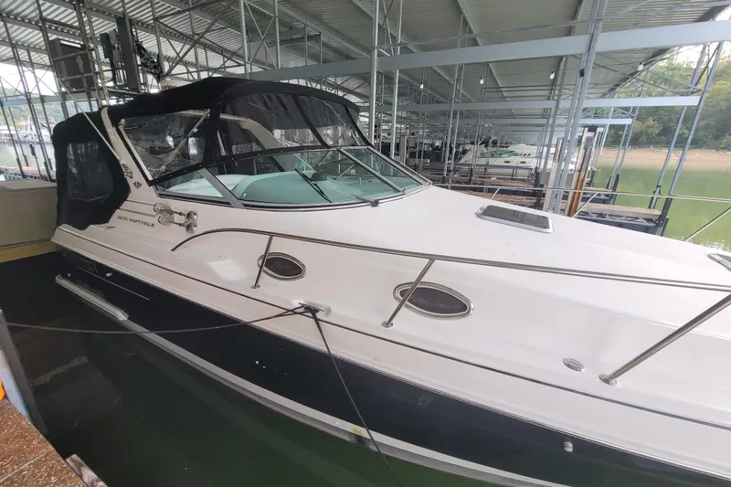 The Image of 1998 Wellcraft 3200 Martinique boat docked in a covered marina. - 0