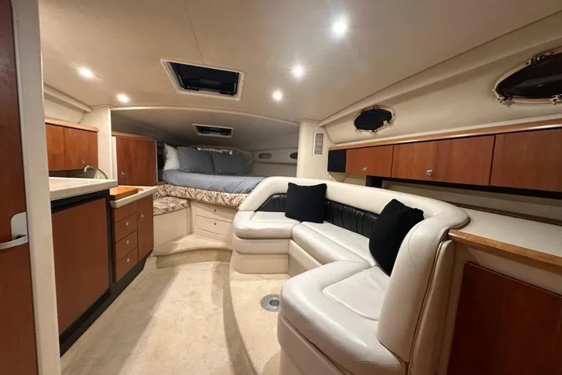 Slide: The Image of Interior of 1998 Wellcraft 3200 Martinique yacht with cozy seating and bed. - 17
