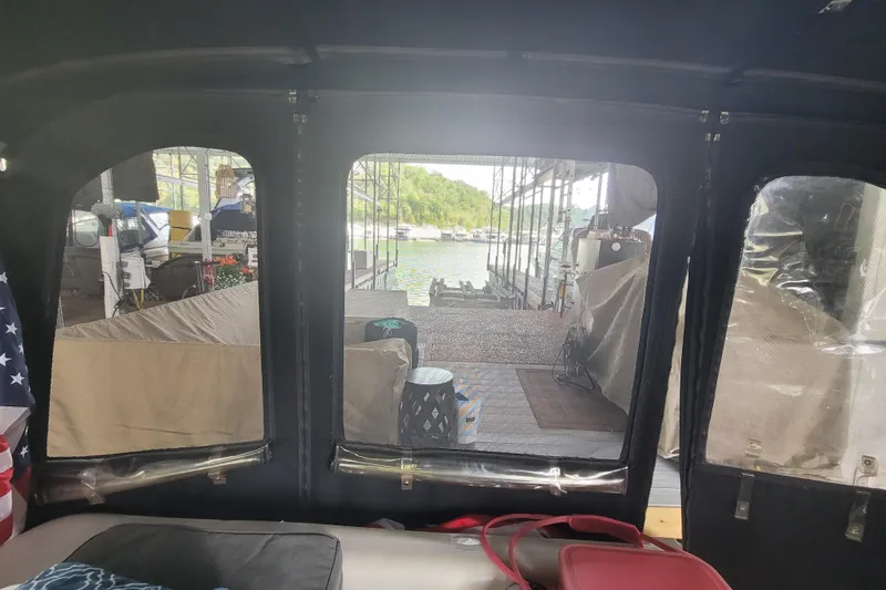 Slide: The Image of Interior view from a 1998 Wellcraft 3200 Martinique boat, overlooking a marina dock. - 21