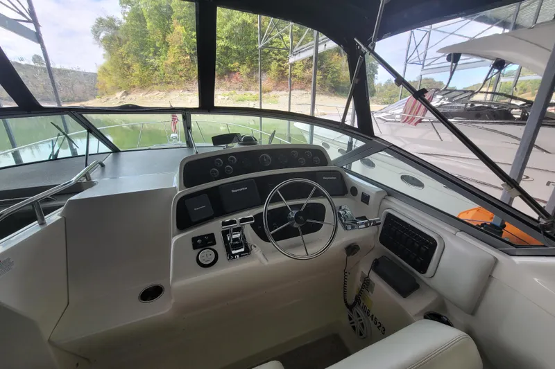 Slide: The Image of Interior view of 1998 Wellcraft 3200 Martinique boat cockpit with steering wheel and controls. - 25