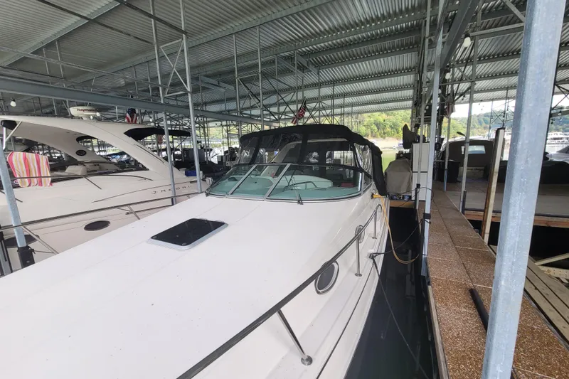 Slide: The Image of 1998 Wellcraft 3200 Martinique docked in a covered marina, side view. - 4
